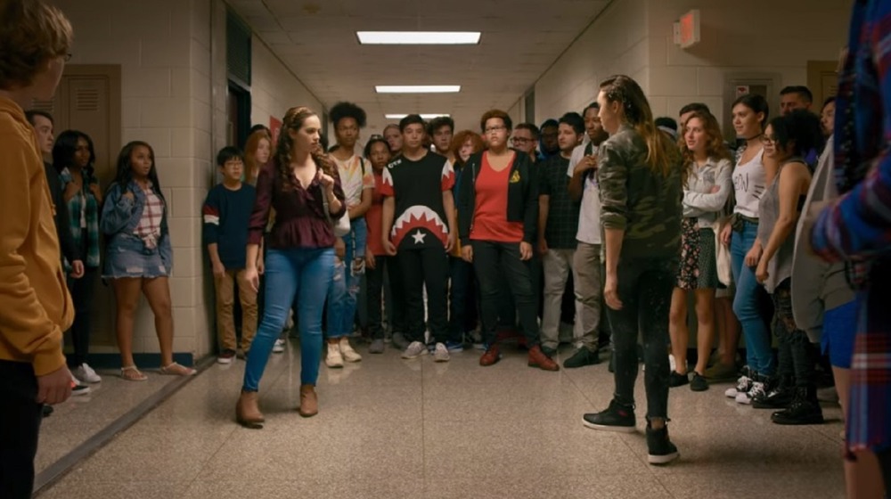 A fight scene in the school at Cobra Kai