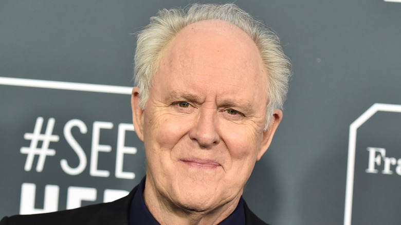 John Lithgow wearing a suit