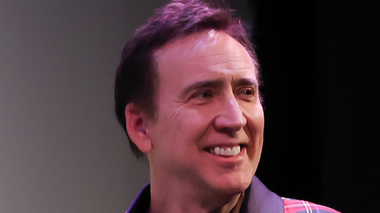 Nicolas Cage smiling off camera