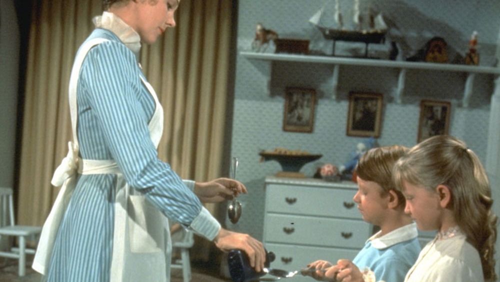 Mary Poppins giving the Banks children medicine