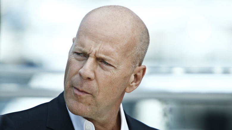 Bruce Willis squinting away from camera