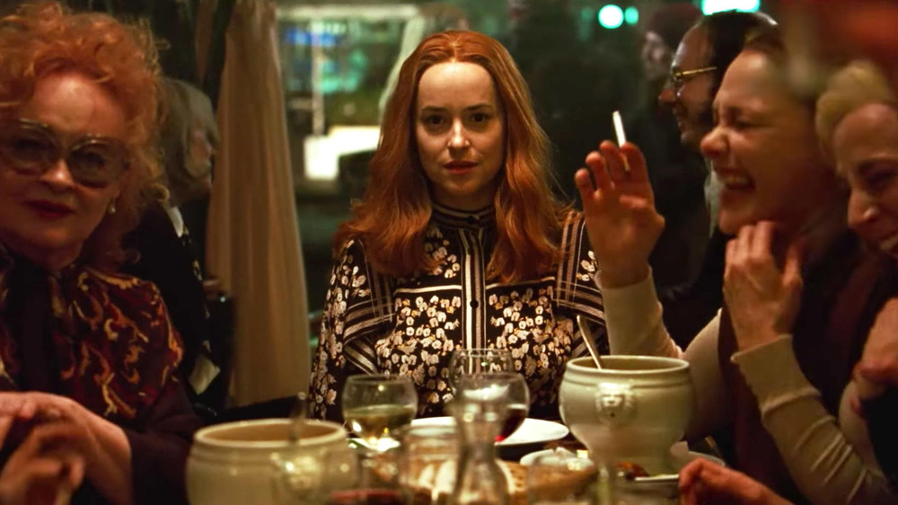 Dakota Johnson character sits amongst witches in Suspiria