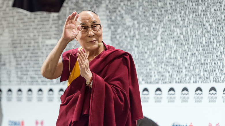 The 14th Dalai Lama waving