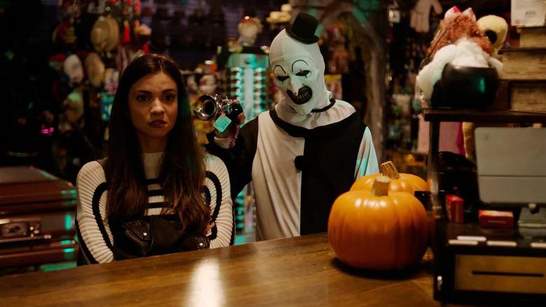 Art the Clown annoys Sienna in "Terrifier 2"