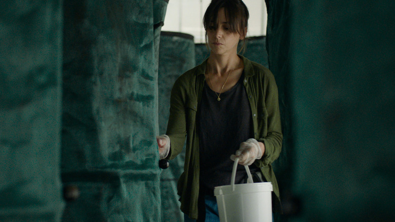 Woman holding white bucket