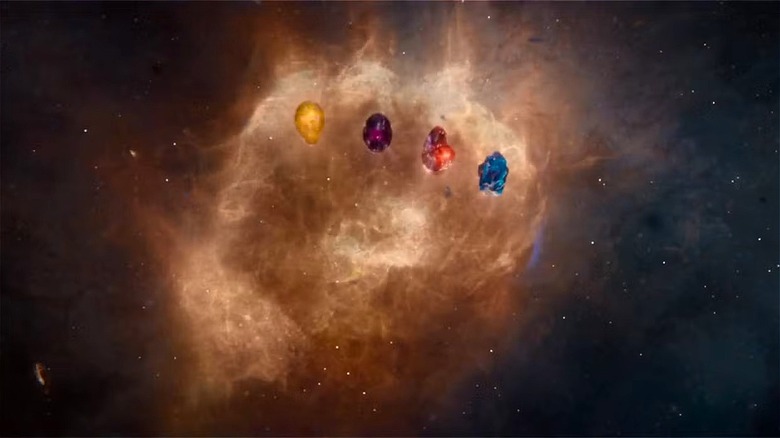 A cloudy image in the sky of Thanos' fist with four Infinity Stones