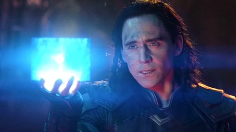 Loki holds up the Tesseract