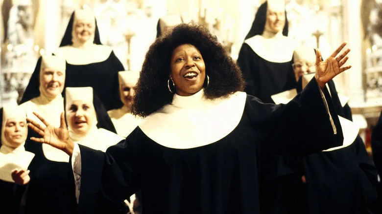 Deloris singing with her arms wide with the choir in Sister Act