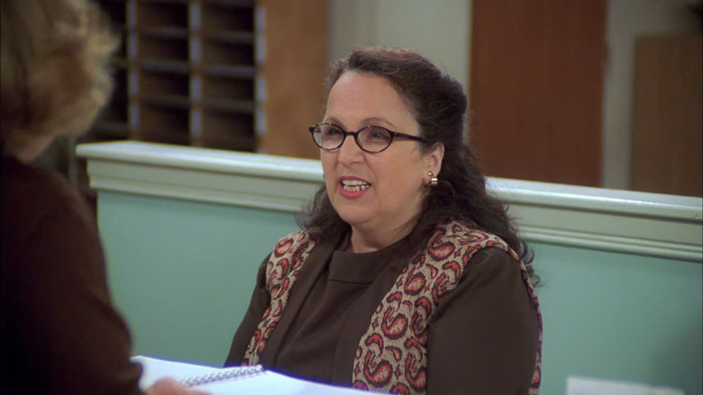 Carol Ann Susi behind a counter