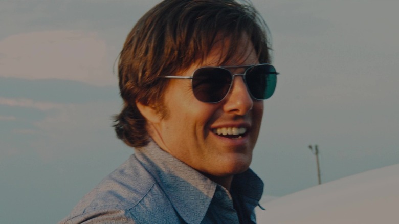 Barry Seal smiling wearing sunglasses