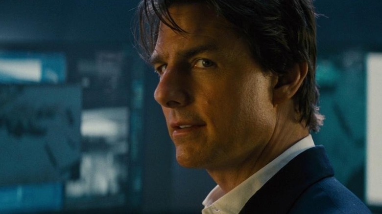 Ethan Hunt smirking next to screens