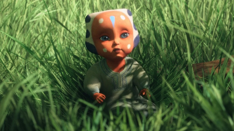 Baby Ahsoka sitting in grass