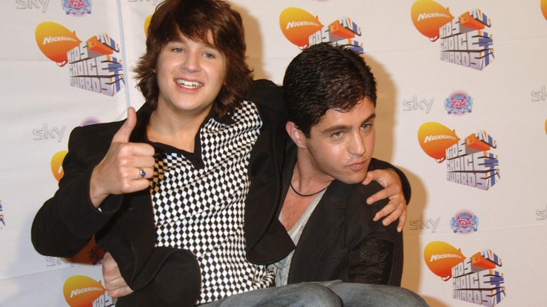 Josh Peck holding Devon Werkheiser