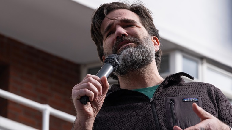 Rob Delaney speaks into a mic