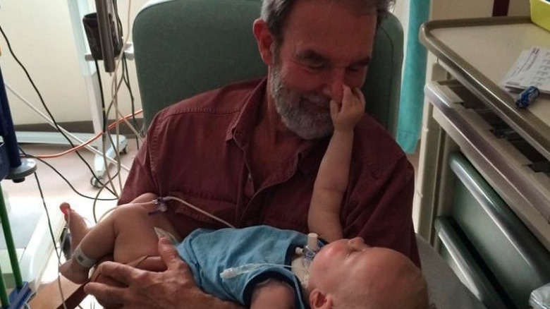 Bob Delaney cradles his grandson