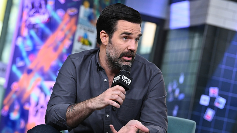 Rob Delaney speaks into a mic