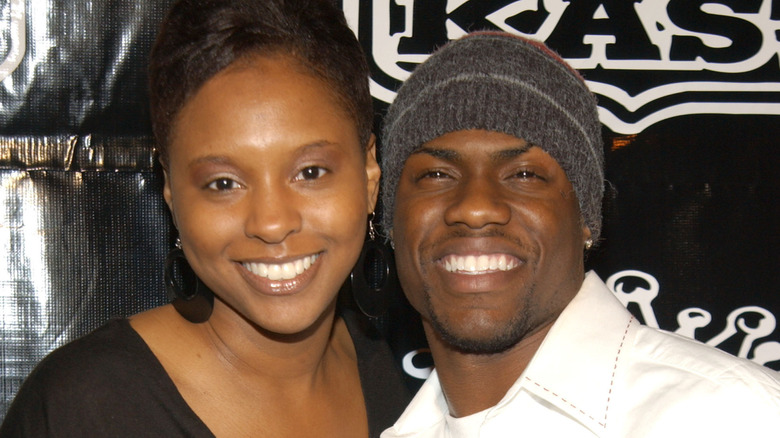 Kevin and Torrei Hart smiling in 2004 in front of a black and white background