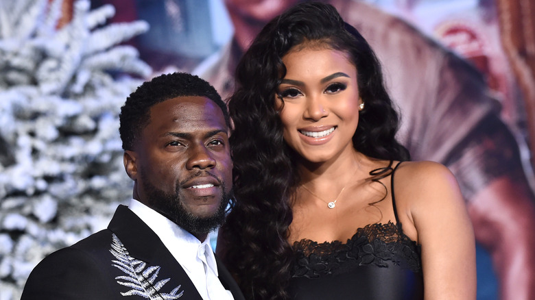 Kevin Hart and Eniko Parrish smiling at the "Jumanji: The Next Level" premiere in 2019