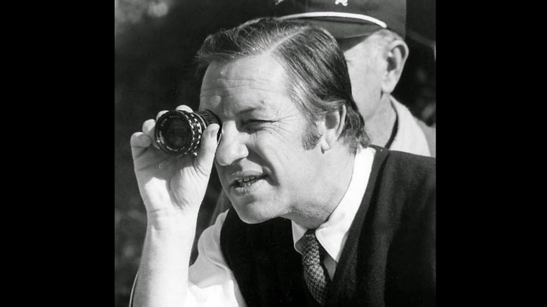 Boris Sagal holding camera lens to his eye in black and white photo