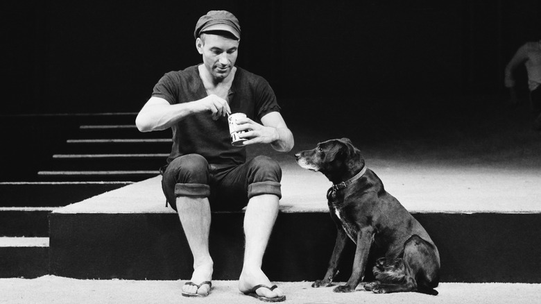 Patrick Stewart onstage feeding dog