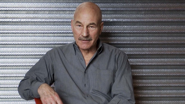 Patrick Stewart sits in a chair