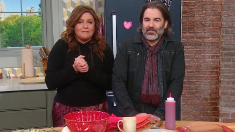 Rachael Ray and husband John Cusimano stand together on the set of the Rachael Ray Show in 2020