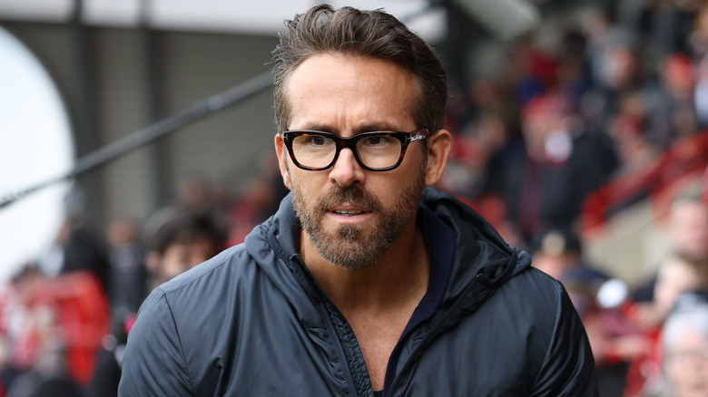 Ryan Reynolds walking wearing glasses