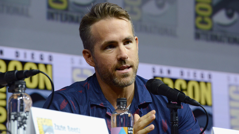 Ryan Reynolds speaks into microphone