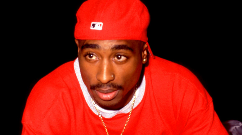 Tupac Shakur in a red cap and t-shirt