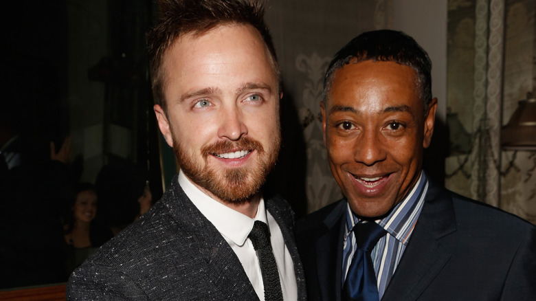 Aaron Paul taking a picture with Giancarlo Esposito at an event