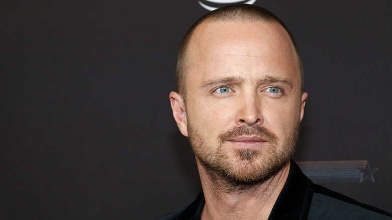 Aaron Paul looking off to the side at a premiere