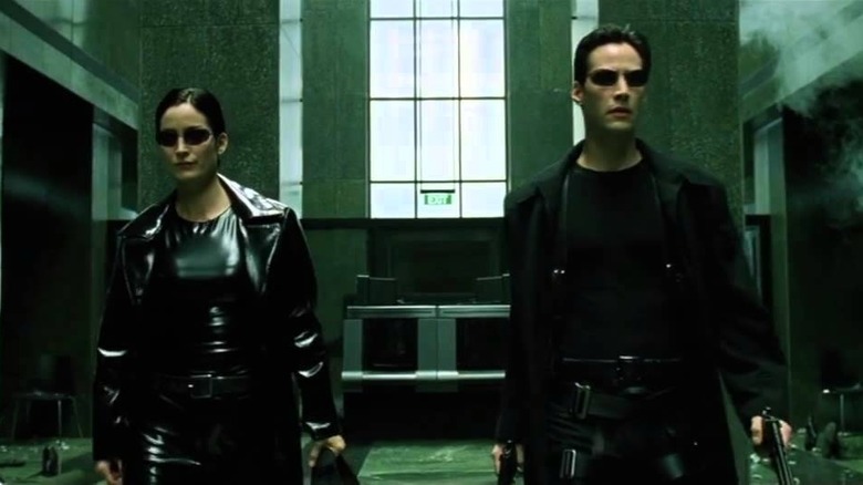 Trinity and Neo go into battle in The Matrix