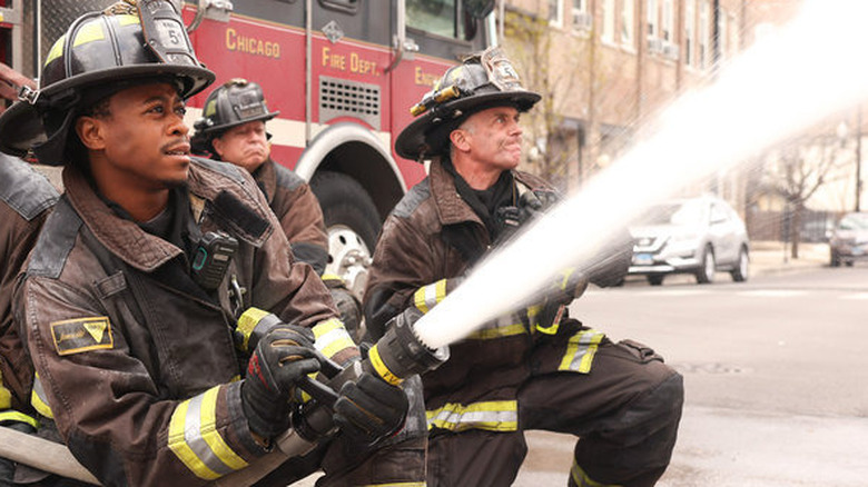 Daniel Kyri and David Eigenberg with fire hose