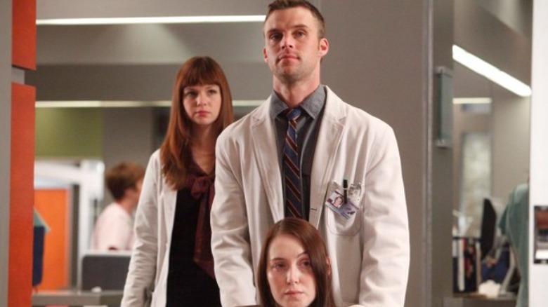 Jesse Spencer helps a patient on House