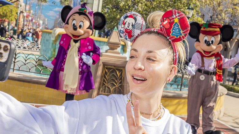 Kaley Cuoco taking a selfie with Mickey and Minnie at Disneyland