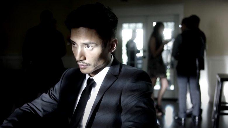 Manny Jacinto wearing a tie in The Romeo Section