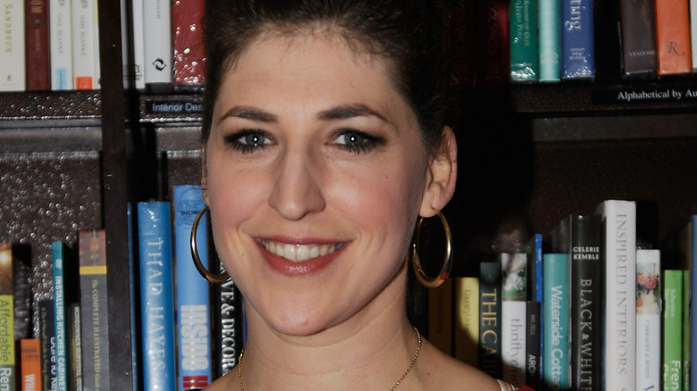Mayim Bialik in front of books