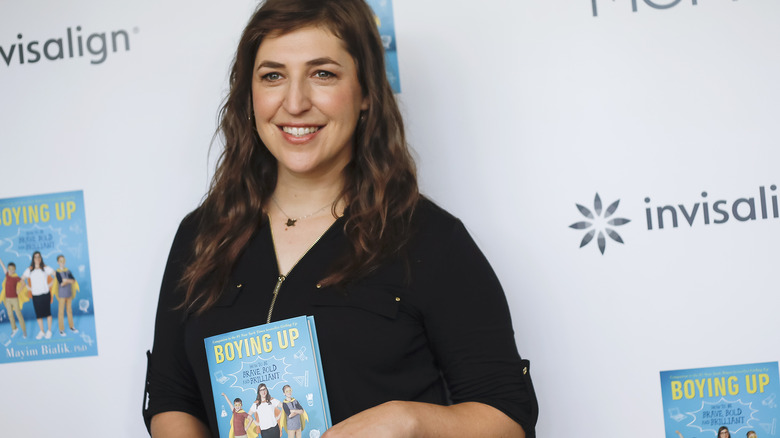 Mayim Bialik holding her book