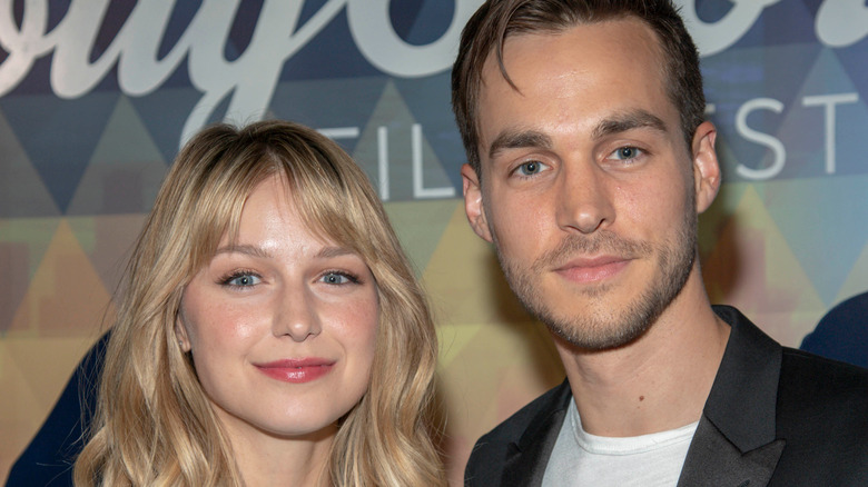 Melissa Benoist and Chris Wood smiling 