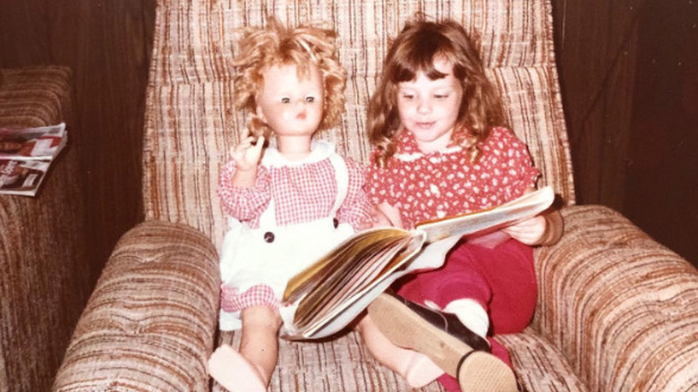 Melissa Rauch as a child with a doll