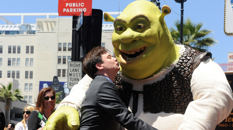 Mike Myers kissing a statue of Shrek