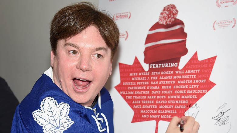 Mike Myers signing a poster for "Being Canadian"