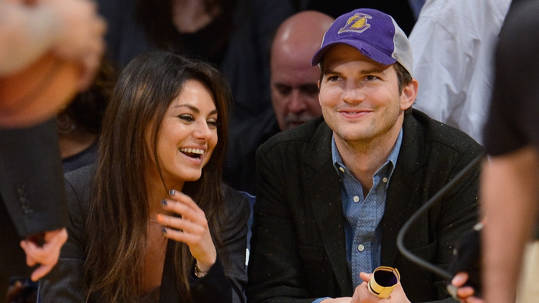 Mila Kunis and Ashton Kutcher watching basketball