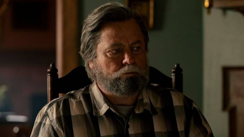 Nick Offerman sits as Bill in The Last of Us