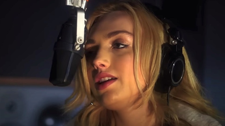 Peyton List singing into microphone