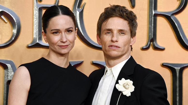 Katherine Waterston and Eddie Redmayne pose at a red carpet event