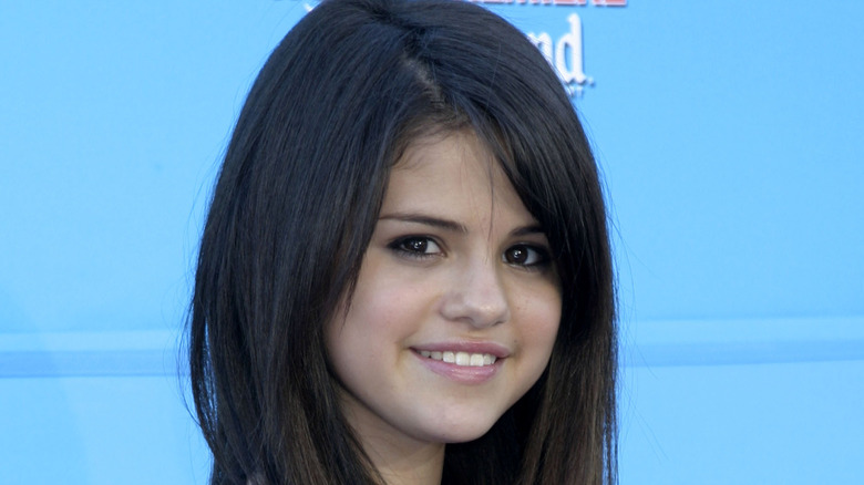 Teenage Selena Gomez smiling at premiere event