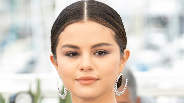 Selena Gomez wearing diamond hoop earrings