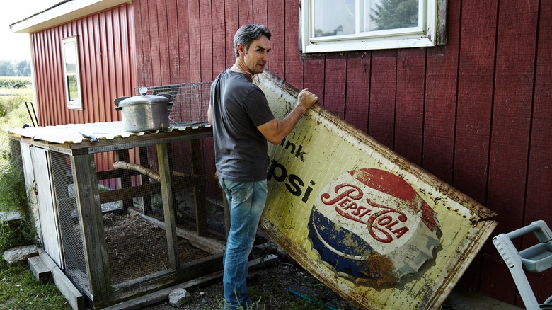 Mike Wolfe holding a sign