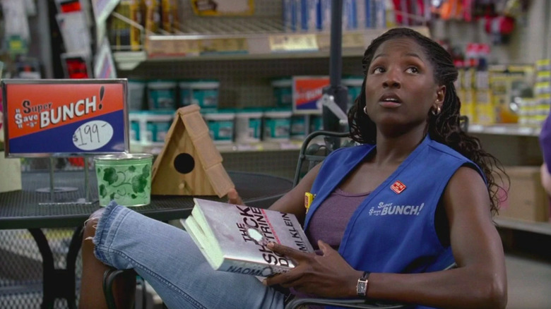 Tara holding a book at the department store True Blood